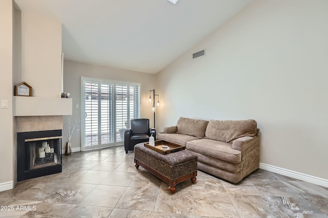 living room featuring a fireplace and high vaulted ceiling