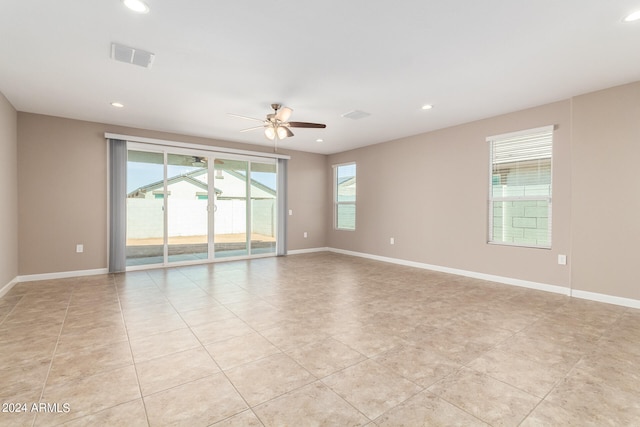 tiled empty room with ceiling fan