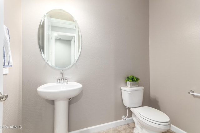 bathroom featuring tile patterned flooring and toilet