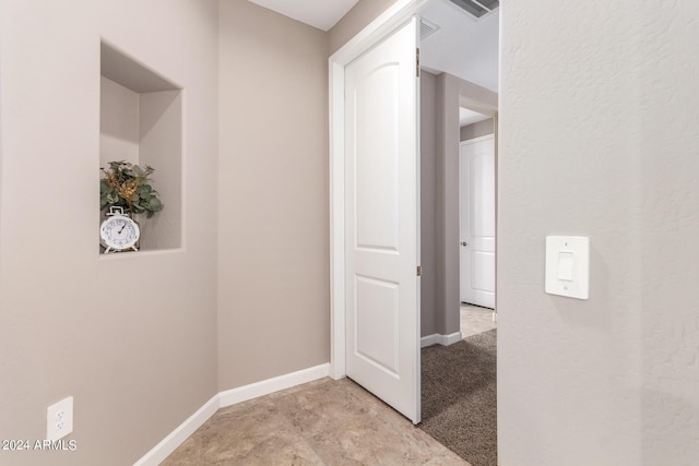 corridor featuring baseboards and visible vents