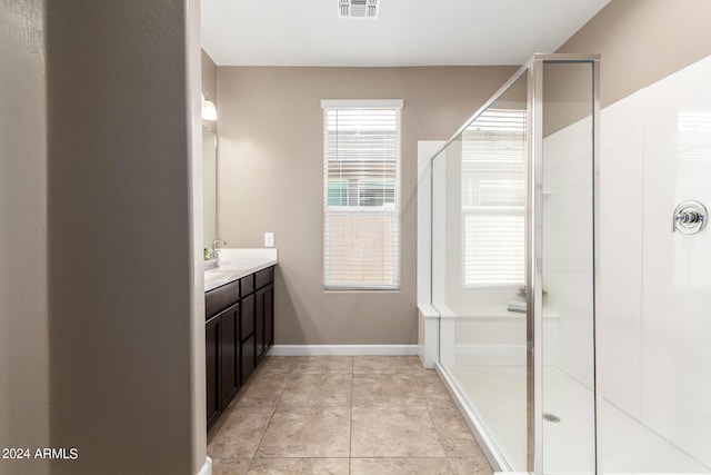 full bathroom featuring visible vents, baseboards, vanity, a stall shower, and tile patterned flooring