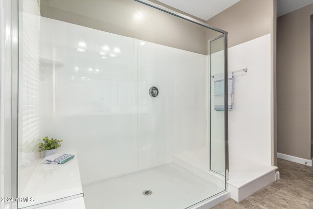 bathroom with tile patterned flooring and a shower with shower door