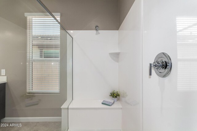 bathroom with vanity, a shower, and tile patterned floors