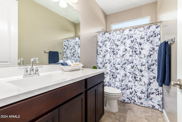 bathroom featuring tile patterned flooring, vanity, toilet, and ceiling fan