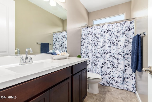 bathroom featuring toilet, tile patterned floors, vanity, and a shower with curtain