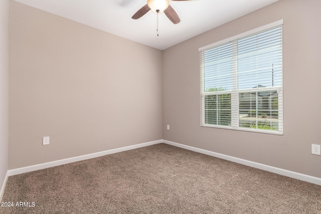empty room with baseboards, carpet floors, and a ceiling fan