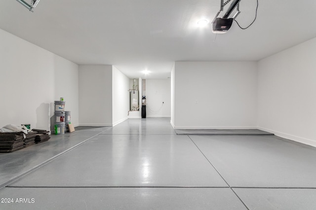 garage featuring gas water heater, baseboards, and a garage door opener