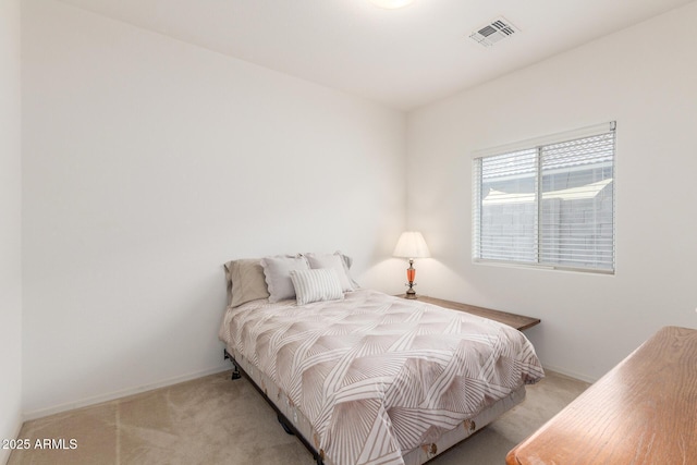 bedroom with light carpet and baseboards