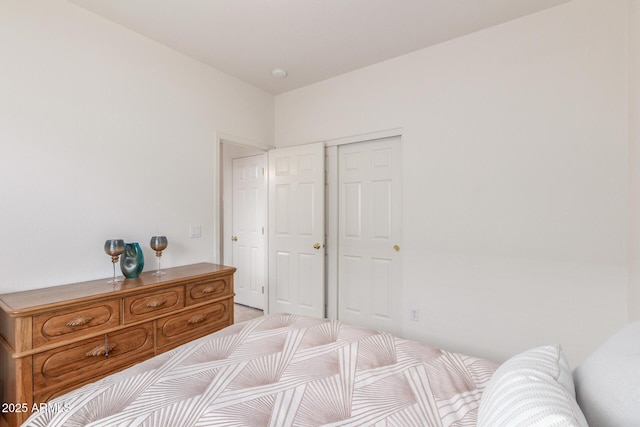 bedroom with a closet and light colored carpet