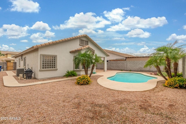 view of swimming pool featuring a fenced backyard, a patio, and cooling unit