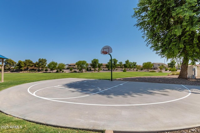 view of basketball court with community basketball court and a lawn