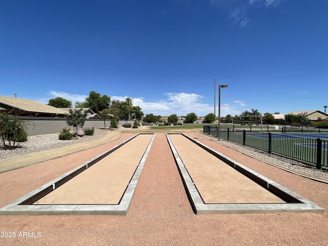 surrounding community with a game area and fence