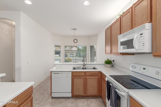 kitchen featuring white appliances, a sink, light countertops, light tile patterned floors, and recessed lighting