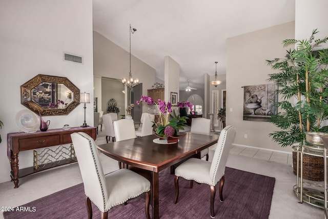 dining area featuring carpet flooring, an inviting chandelier, and high vaulted ceiling