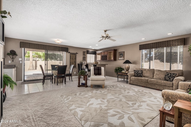 tiled living room featuring ceiling fan and a textured ceiling