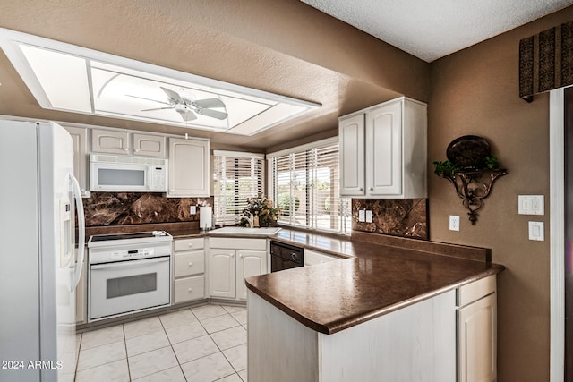 kitchen with white appliances, ceiling fan, kitchen peninsula, and white cabinets