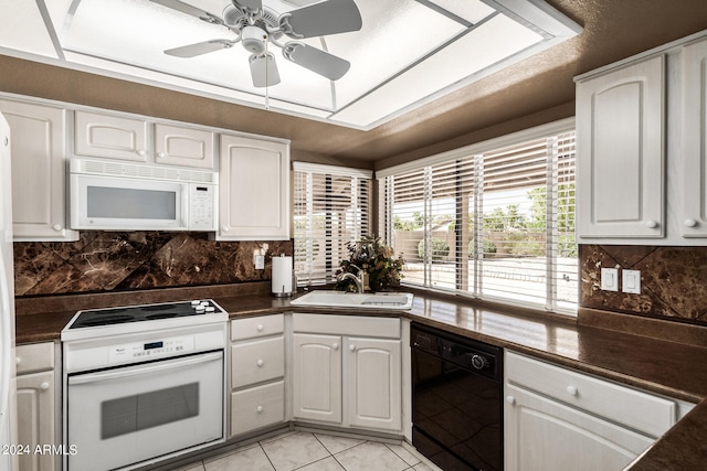 kitchen featuring white cabinets, white appliances, ceiling fan, and sink