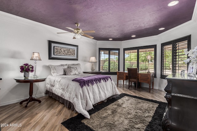 bedroom featuring crown molding, ceiling fan, and hardwood / wood-style flooring