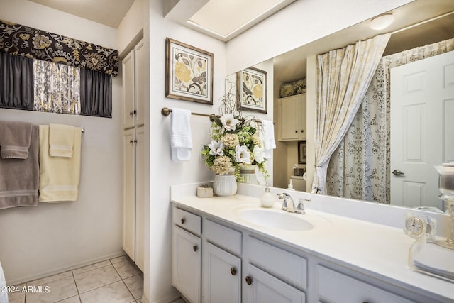 bathroom with tile patterned floors and vanity