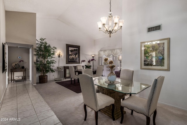 carpeted dining area with an inviting chandelier and high vaulted ceiling