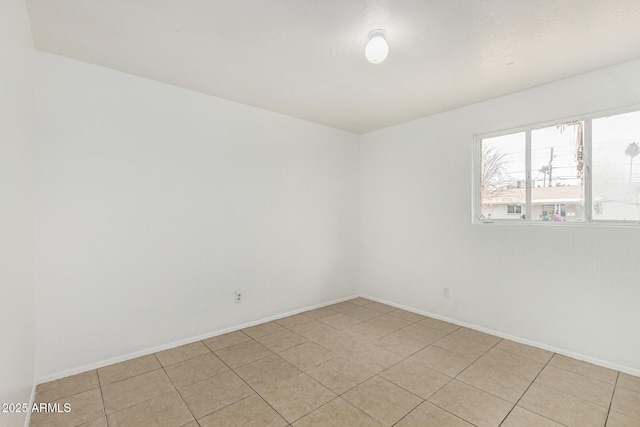 unfurnished room featuring baseboards