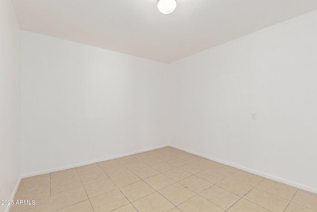 unfurnished room with baseboards