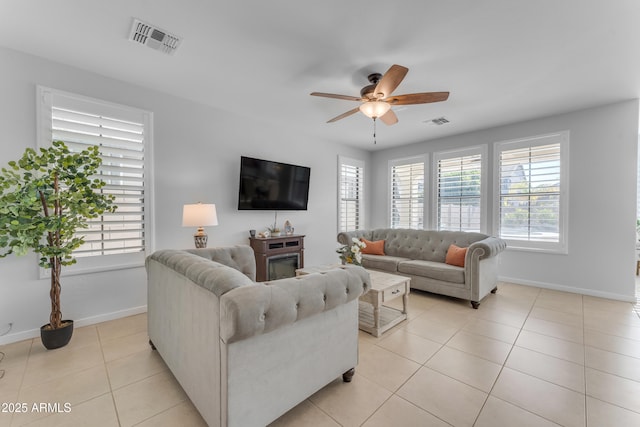 tiled living room with ceiling fan