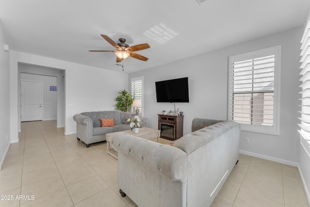 living room with ceiling fan and light tile patterned floors