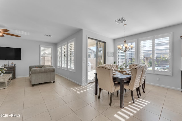 dining room featuring ceiling fan with notable chandelier and light tile patterned flooring