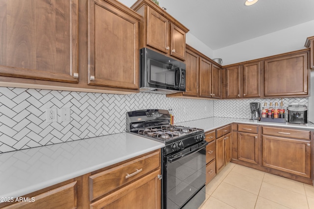 kitchen featuring black appliances, light tile patterned flooring, and tasteful backsplash