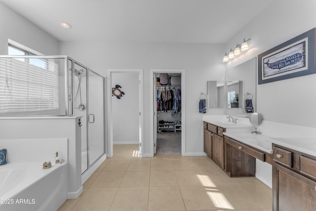 bathroom with tile patterned flooring, vanity, and shower with separate bathtub