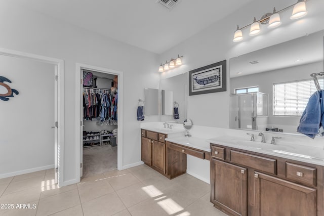 bathroom with tile patterned floors, vanity, and an enclosed shower