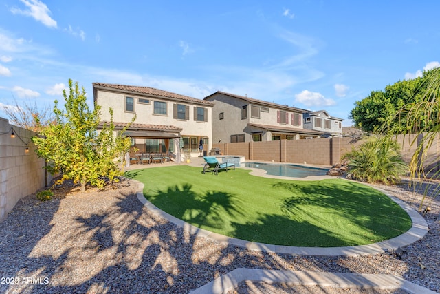 back of house featuring a yard, a pergola, a fenced in pool, and a patio area