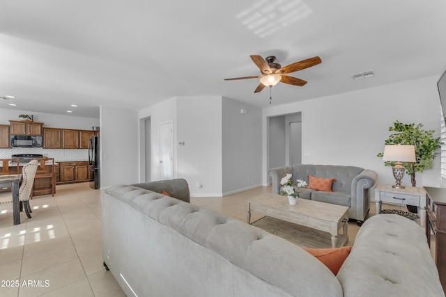 tiled living room with ceiling fan