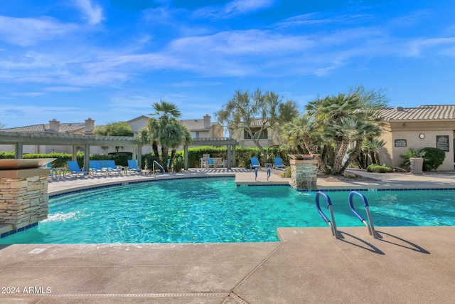 view of swimming pool featuring a pergola, pool water feature, and a patio