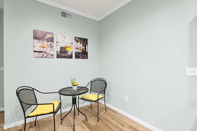 sitting room featuring light wood-type flooring and ornamental molding