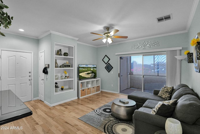 living room with ceiling fan, ornamental molding, and light wood-type flooring