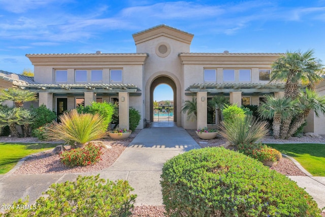 mediterranean / spanish-style home with a pergola