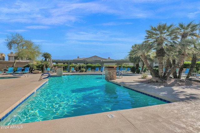 view of swimming pool featuring a patio and pool water feature