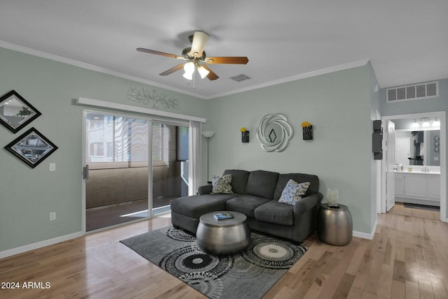 living room featuring ceiling fan, ornamental molding, and light hardwood / wood-style flooring