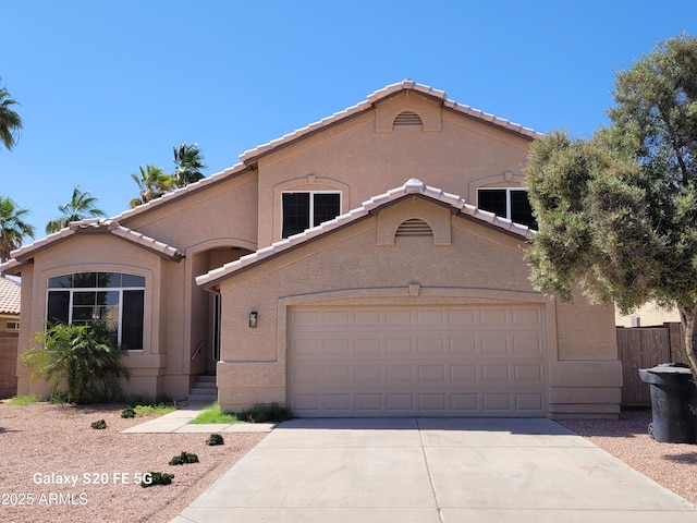 8478 W Grovers Ave, Peoria, AZ 85382 - mediterranean / spanish house featuring a tiled roof, driveway, a garage, and stucco siding