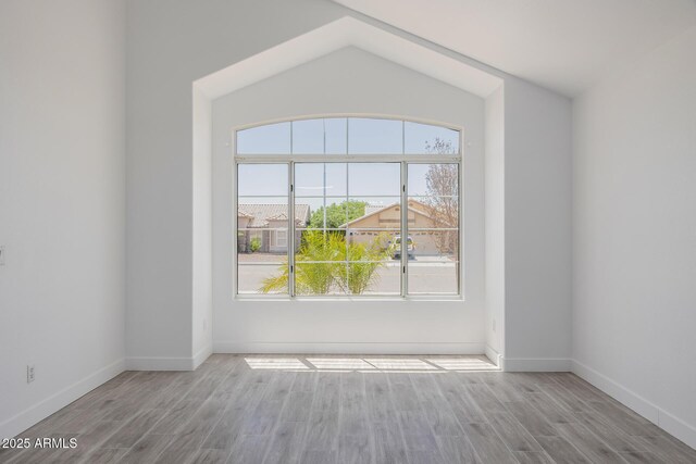 8478 W Grovers Ave, Peoria, AZ 85382 - unfurnished room featuring wood finished floors and vaulted ceiling
