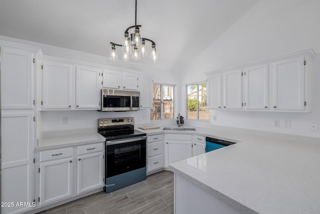 8478 W Grovers Ave, Peoria, AZ 85382 - kitchen with stainless steel appliances, white cabinets, lofted ceiling, and a chandelier