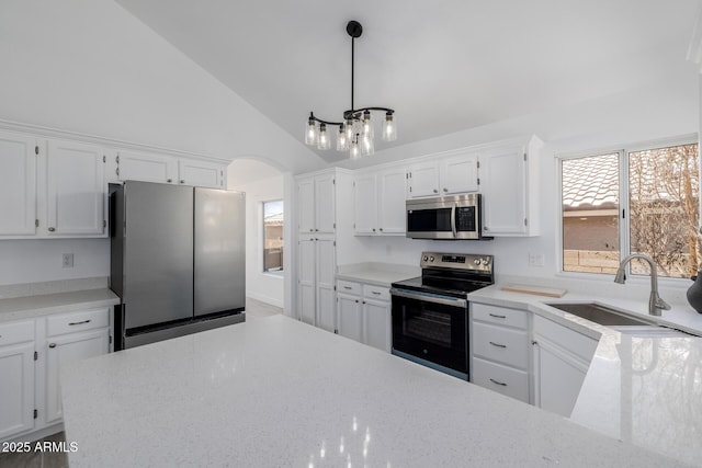 8478 W Grovers Ave, Peoria, AZ 85382 - kitchen featuring appliances with stainless steel finishes, white cabinetry, a chandelier, arched walkways, and high vaulted ceiling
