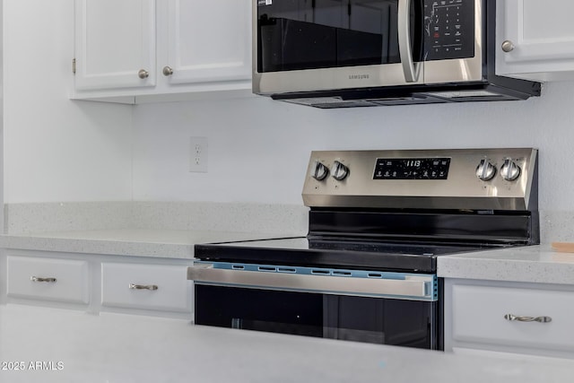 8478 W Grovers Ave, Peoria, AZ 85382 - kitchen with appliances with stainless steel finishes, white cabinetry, and light stone countertops