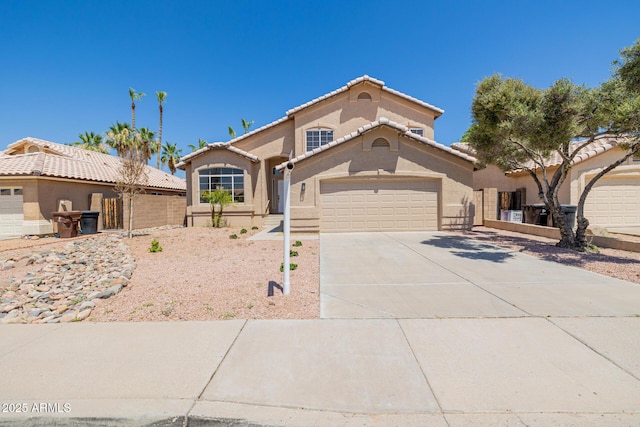 8478 W Grovers Ave, Peoria, AZ 85382 - mediterranean / spanish-style house featuring concrete driveway, stucco siding, and a garage