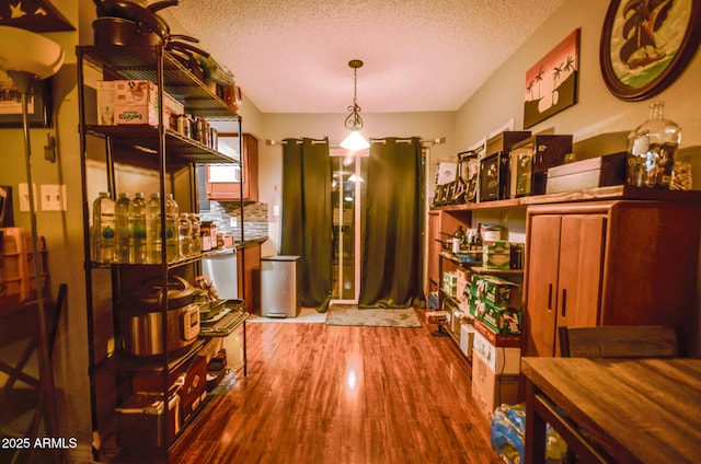 interior space featuring hardwood / wood-style flooring and a textured ceiling