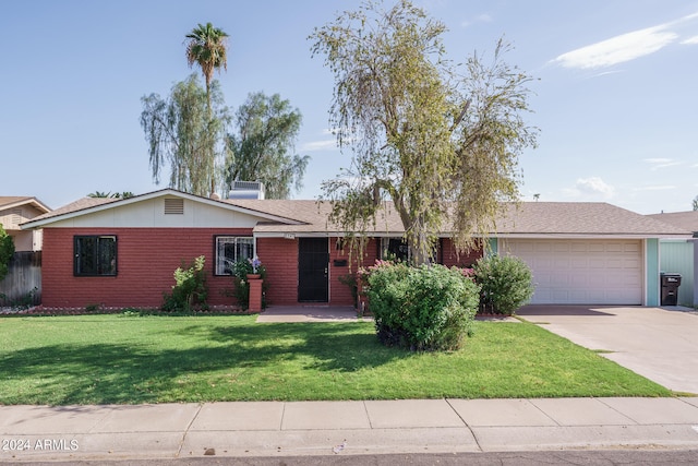 ranch-style home with a garage and a front lawn