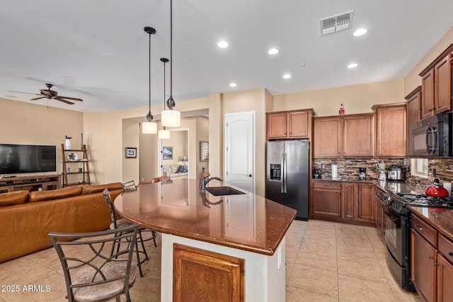 29159 N 128th Ln, Peoria, AZ 85383 - kitchen with black appliances, a sink, ceiling fan, backsplash, and a center island with sink