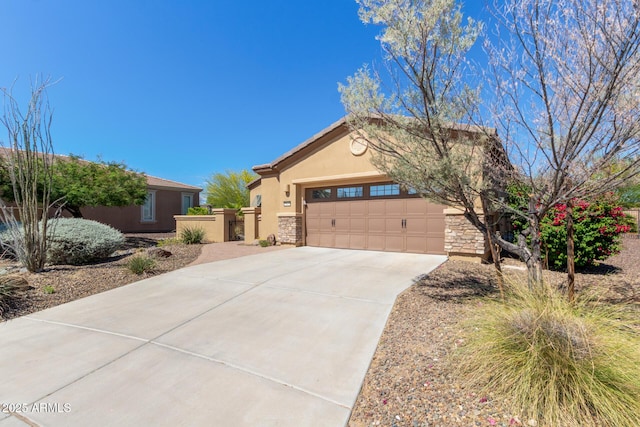 29159 N 128th Ln, Peoria, AZ 85383 - view of front facade with stone siding, concrete driveway, a garage, stucco siding, and a gate